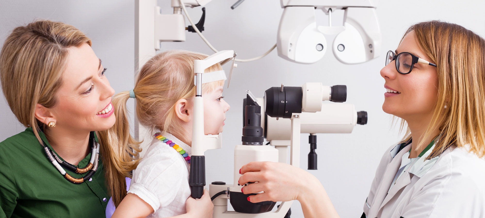 Banner displaying small child having an eye exam